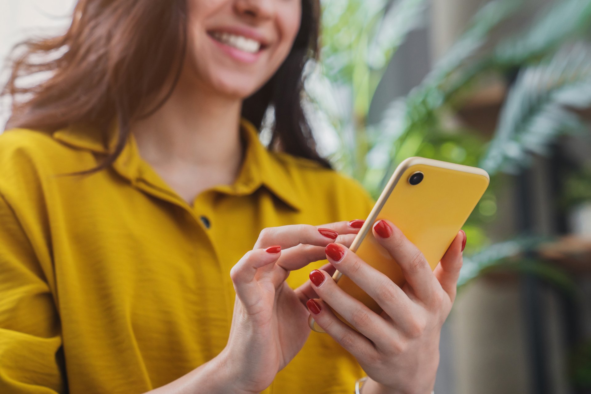 woman texting on yellow iphone